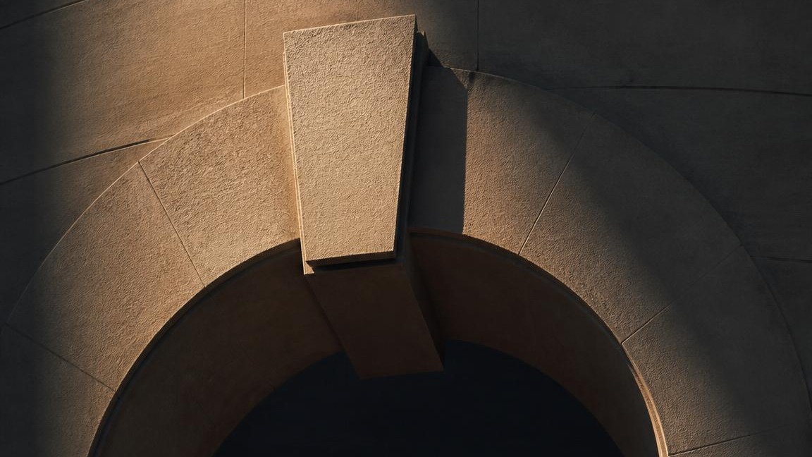 Stone archway with a central keystone — the holding capacity metaphor